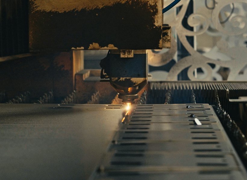 Machine cutting metal in a factory